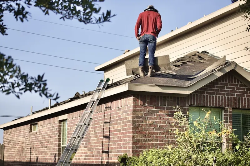 Professional roofer working on a residential roof in Belews Creek